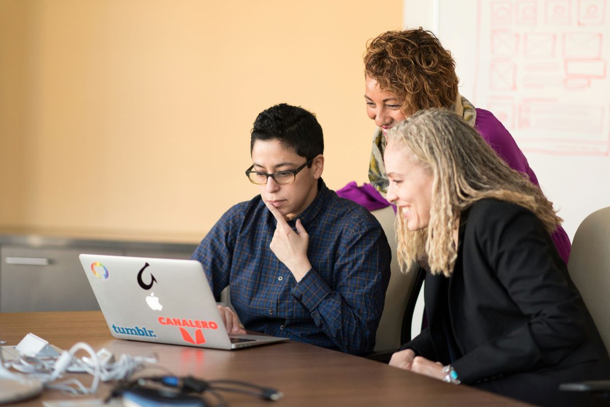 Women in data science class looking at laptop